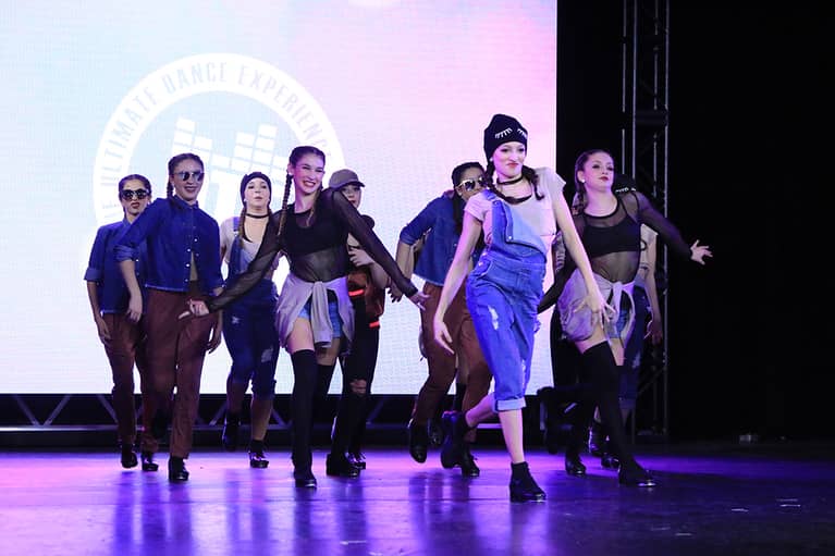 A group of dancers performing on stage during an On The Floor event