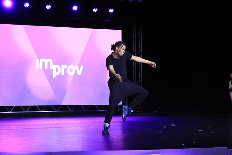 A dancer performing on stage during OTF Improv competition