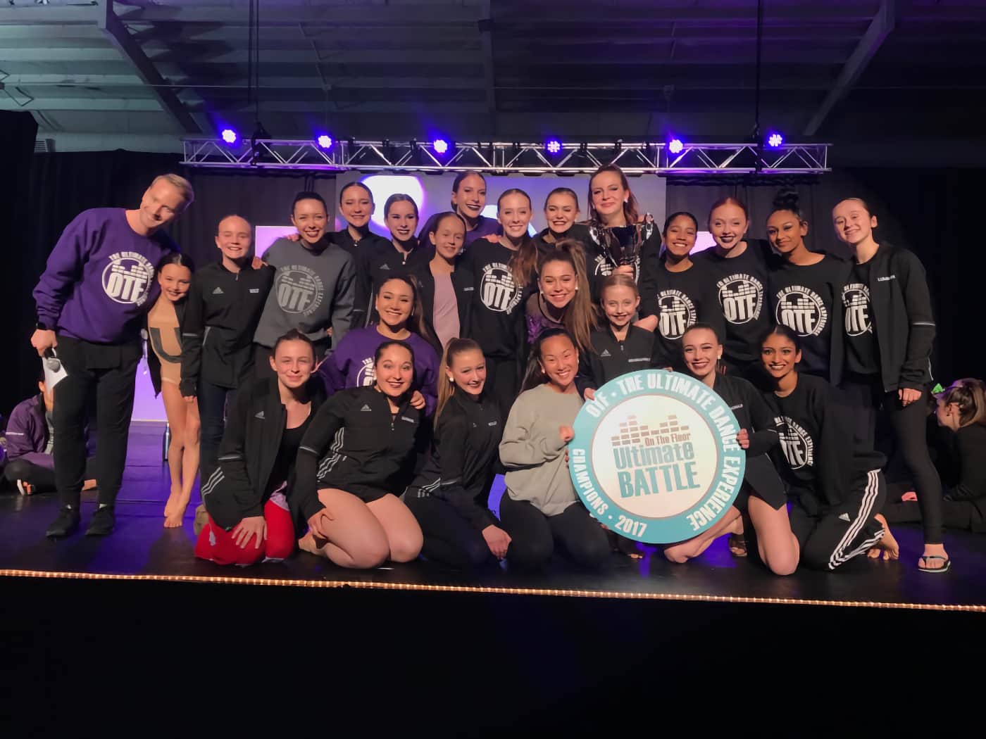 A dance group posing on stage after being named On The Floor Ultimate Battle Champions